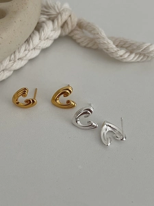 Detailed view of S925 silver geometric wavy stud earrings in gold and silver finishes
