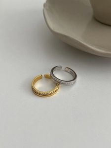 Detail of S925 sterling silver open rings showing the hallmarked interior and paved cubic zirconia