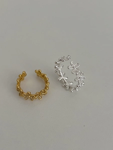 Detail of floral S925 silver rings with micro-paved cubic zirconia in gold and silver