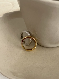 Macro shot of S925 sterling silver and gold adjustable rings with cubic zirconia pavé