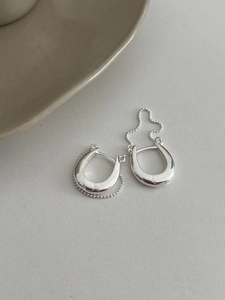 Vue détaillée de boucles d'oreilles créoles en U argentées avec de fines chaînes à boules