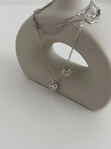 Detailed view of S925 sterling silver double heart pendant with bear tail charm decoration