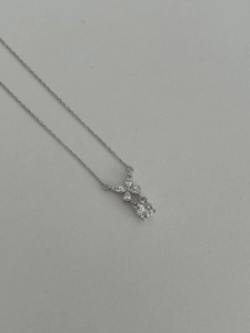 Macro detail of S925 sterling silver butterfly pendant with marquise and round cut diamonds