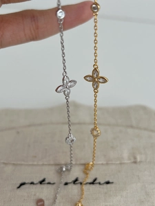 Detailed close-up of S925 silver four-leaf clover bracelets with zircon inlays on display