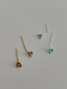 Detailed macro view of S925 iris flower drop earrings in green and blue floral petals