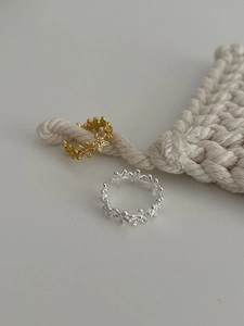 Detailed view of gold and silver S925 floral rings with tiny zircon stone petals
