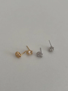Close-up of gold and silver tulip-shaped stud earrings with sparkling cubic zirconia
