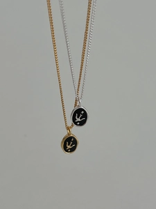 Detailed close-up of S925 sterling silver swallow pendant with black enamel finish