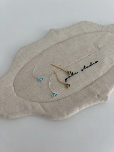 Detail of floral chain earrings with iris petals and crystals in silver and gold finishes