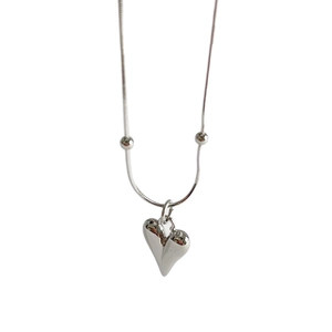 Silver snake chain necklace featuring a 3D heart pendant and decorative beads on white background