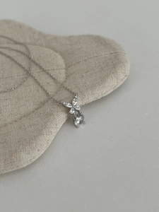 Macro view of S925 silver necklace with marquise diamond butterfly floral pendant