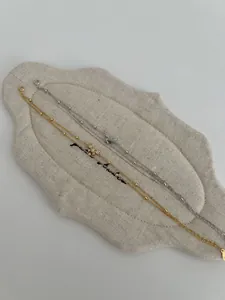 Close-up of gold and silver S925 sterling silver bow bracelets with zircon inlay and beads