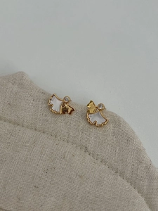 Detailed macro view of S925 silver ginkgo leaf stud earrings with white shell and crystals