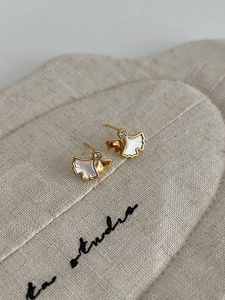 Detail of S925 silver ginkgo leaf earrings with white shell inlay and sparkling crystal