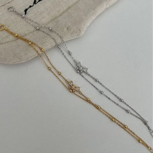 Double-layered S925 silver bow bracelet with zircons in gold and silver finish