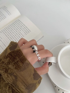 Detailed shot of vintage silver ring set with hollow carving and beaded band on hand