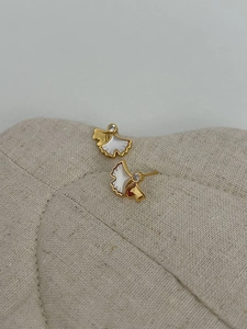 Macro detail of S925 ginkgo leaf earrings with white shell inlay and tiny crystals