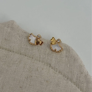 S925 silver ginkgo leaf studs with white mother-of-pearl and crystal on beige linen