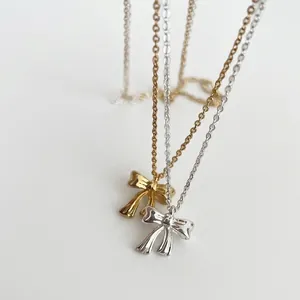 Elegant S925 silver bow necklace in gold and silver finish with polished pendant