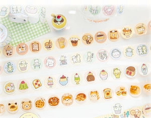Close-up of cute cartoon cat and dessert stickers on washi tape for DIY journal