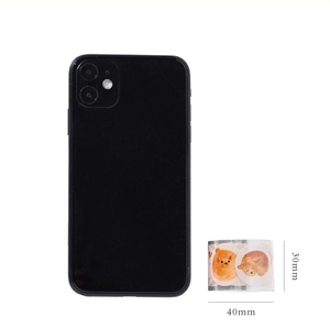 Detailed size view of 30mm cute puppy decorative tape with a black phone for scale