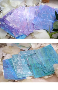 Holographic shimmering scrapbooking paper with water ripples and floral decoration