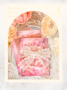 Detail of pink floral stationery paper with white lace bow decoration and vintage frames
