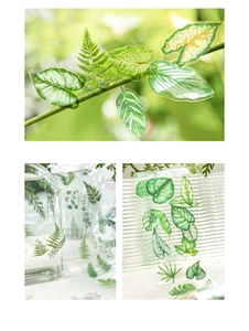 Macro detail of realistic green leaf PET stickers on glassware and textured surfaces