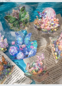 Close-up of holographic crystal butterfly stickers with floral and fantasy elements