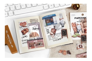 Close-up of retro bakery-themed PET stickers applied to a notebook for creative journaling