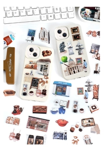 Flat lay of creative PET stickers on phone cases with artistic lifestyle themes