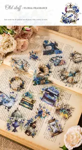 Detail of vintage flower stickers with sewing machine and phonograph on old book pages