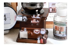 Detailed view of cafe and bakery themed PET stickers on coffee equipment for scrapbooking
