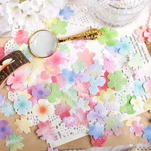 Flat lay of colorful embossed floral paper scraps for DIY scrapbooking decoration