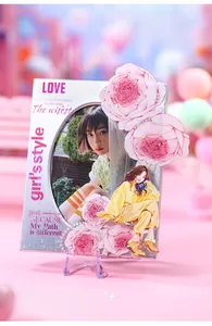 Close-up of pink PET tape acrylic holder with floral and cartoon girl illustrations