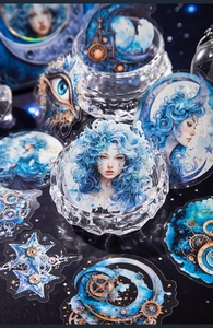 Macro shot of Goddess Moon stickers with fantasy blue motifs and crystal decor