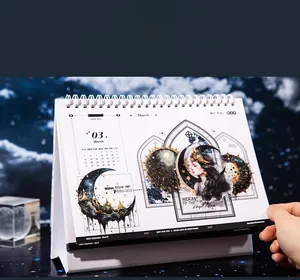 Detail of vintage moon goddess calendar with coil binding and mystical illustrations