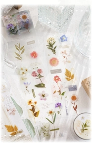 Close-up of waterproof PET floral stickers with daisy and rose designs for DIY scrapbooking