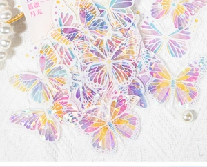Vue macro d'autocollants papillons holographiques avec effet nacré sur tissu blanc