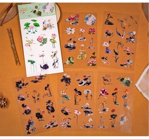 Detailed macro view of semi-transparent PET stickers with traditional ink lotus flower motifs