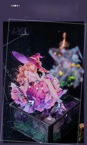 Detail of shimmering shell light witch sticker in a glass box with purple crystals
