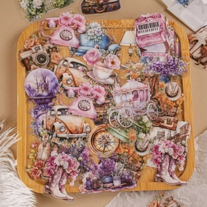 Vintage PET stickers featuring cameras and flowers on a round wooden tray for scrapbooking
