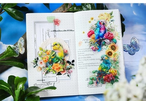 Close-up of PET stickers featuring colorful birds and flowers on a dotted notebook page