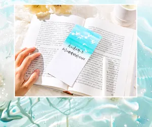 Detailed view of aesthetic blue bird paper card on an open book for DIY journaling