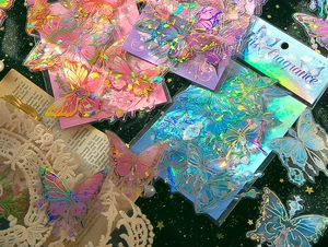 Close-up of holographic butterfly stickers with iridescent shell light effects on vintage paper
