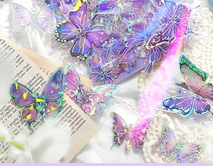 Macro shot of iridescent butterfly stickers with laser rainbow finish on vintage book
