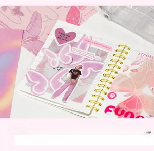 Detail of spiral notebook with purple butterfly stickers and aesthetic paper decorations