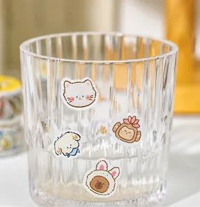 Macro shot of cute cartoon animal stickers on glass, decorative journaling supplies