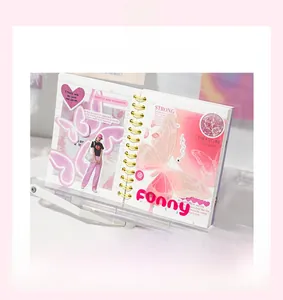 Detail of pink butterfly themed scrapbook paper with gold coils and vintage stickers