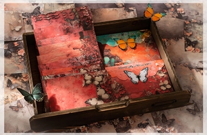 Detail of vintage Butterfly Messenger decorative papers and envelopes on wood